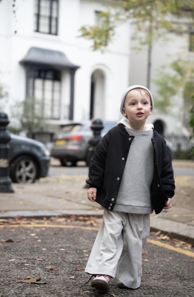 Child in the Tres London Soho hoodie bomber on a London street