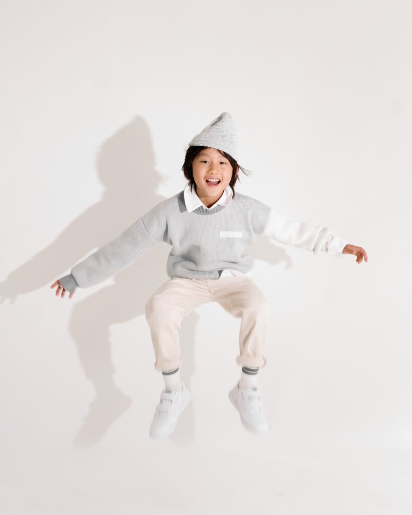 Child jumping in the Tres London Chelsea jumper